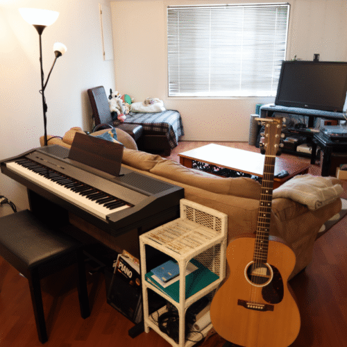 Wide view of Upnotes Music's cozy teaching studio near downtown Kelowna, featuring a welcoming and organized learning space for piano and guitar students.