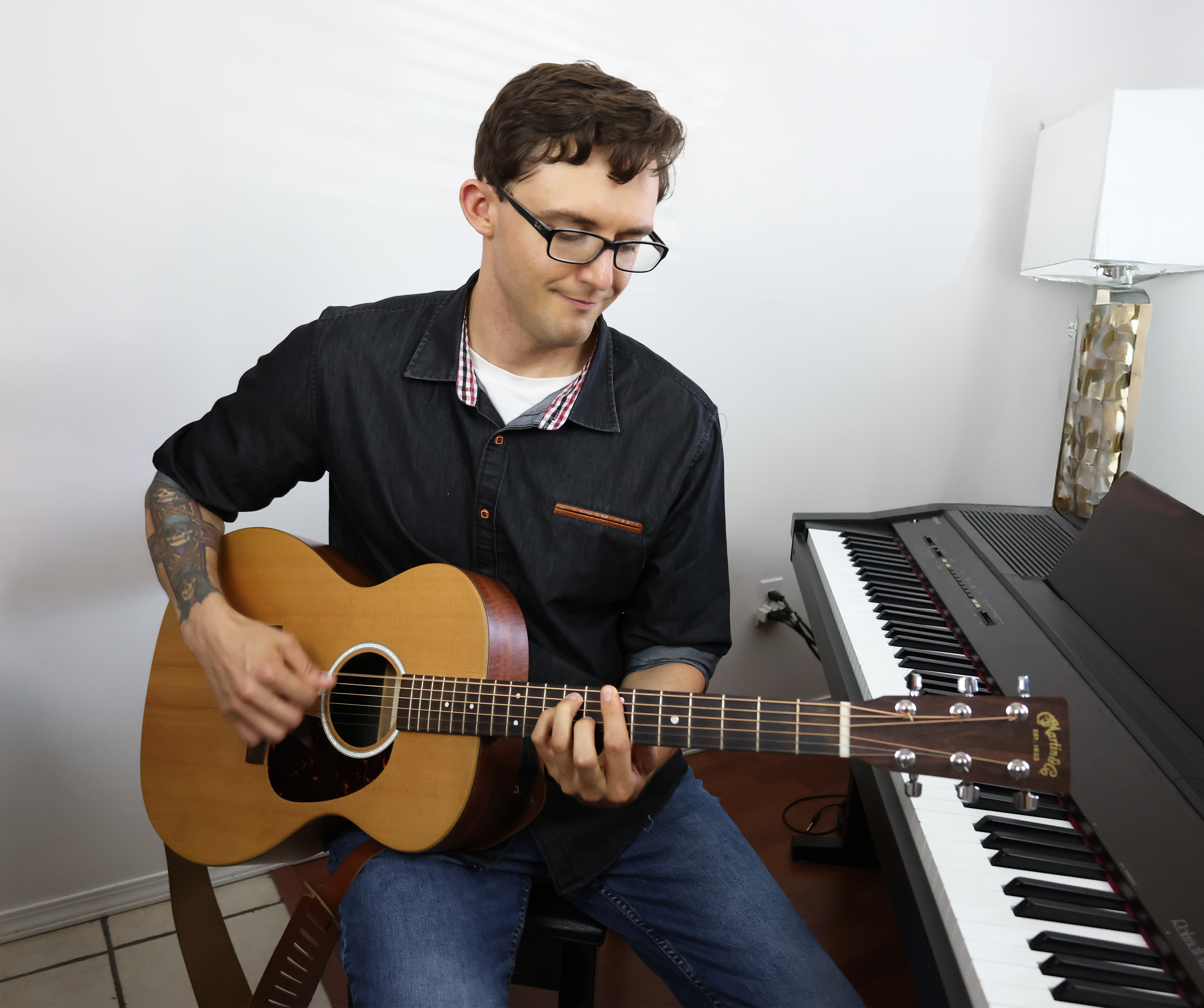 Kelowna guitar teacher playing acoustic guitar during a music lesson
