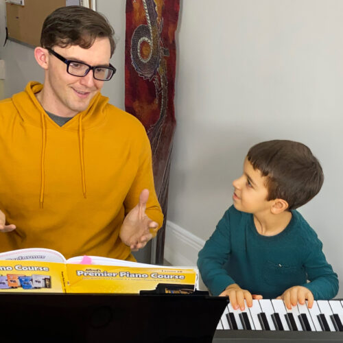 Alex teaching a young student piano at his studio in Kelowna