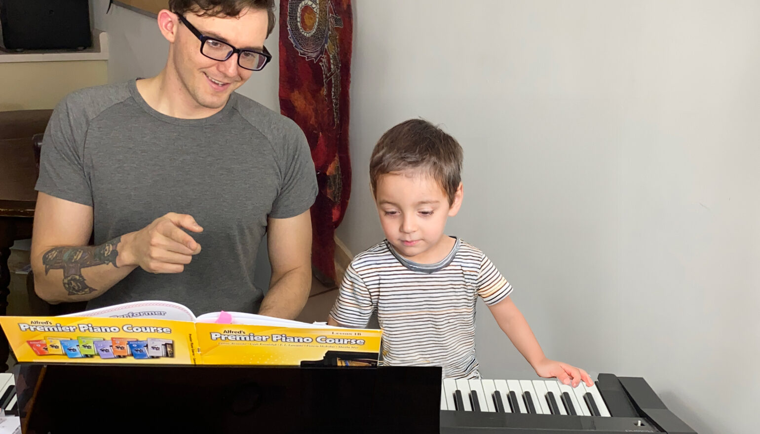 Teacher Alex Stacey at Upnotes Music teaches a young boy in Kelowna
