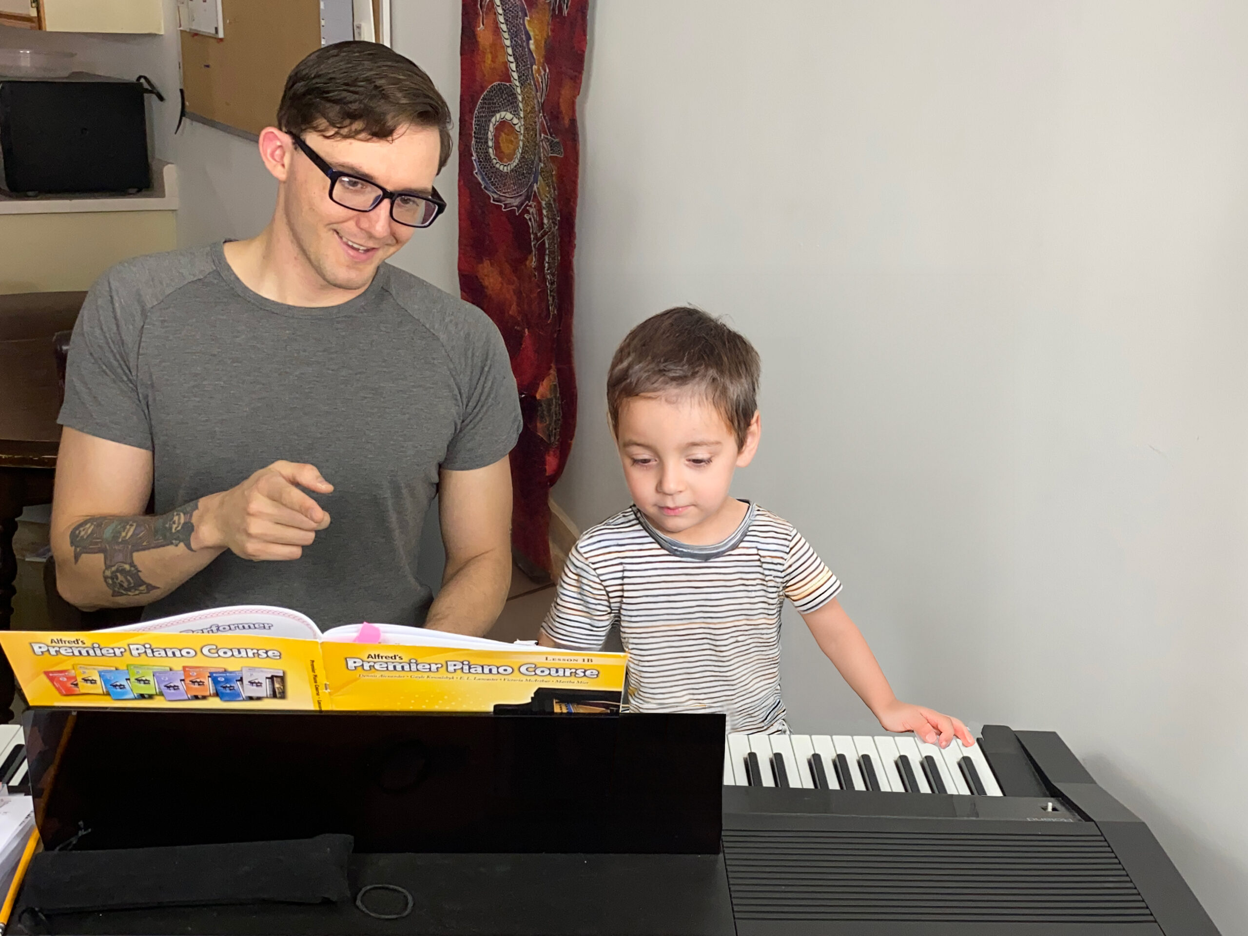 Teacher Alex Stacey at Upnotes Music teaches a young boy in Kelowna